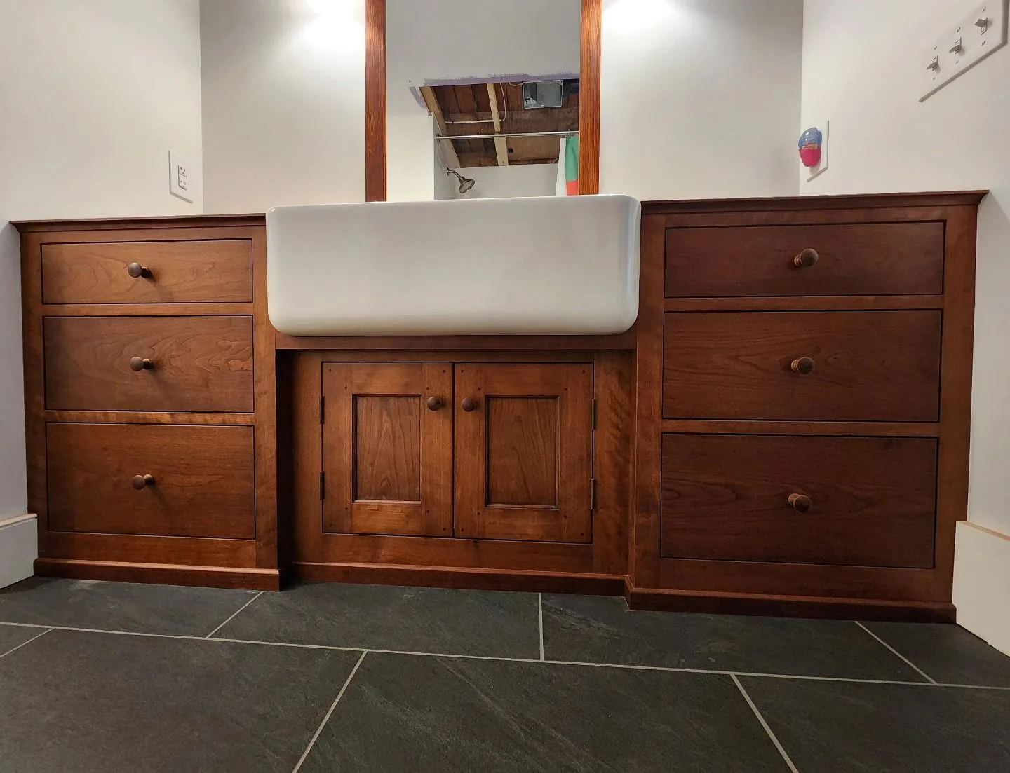 Custom cherry wood bathroom vanity with farmhouse sink