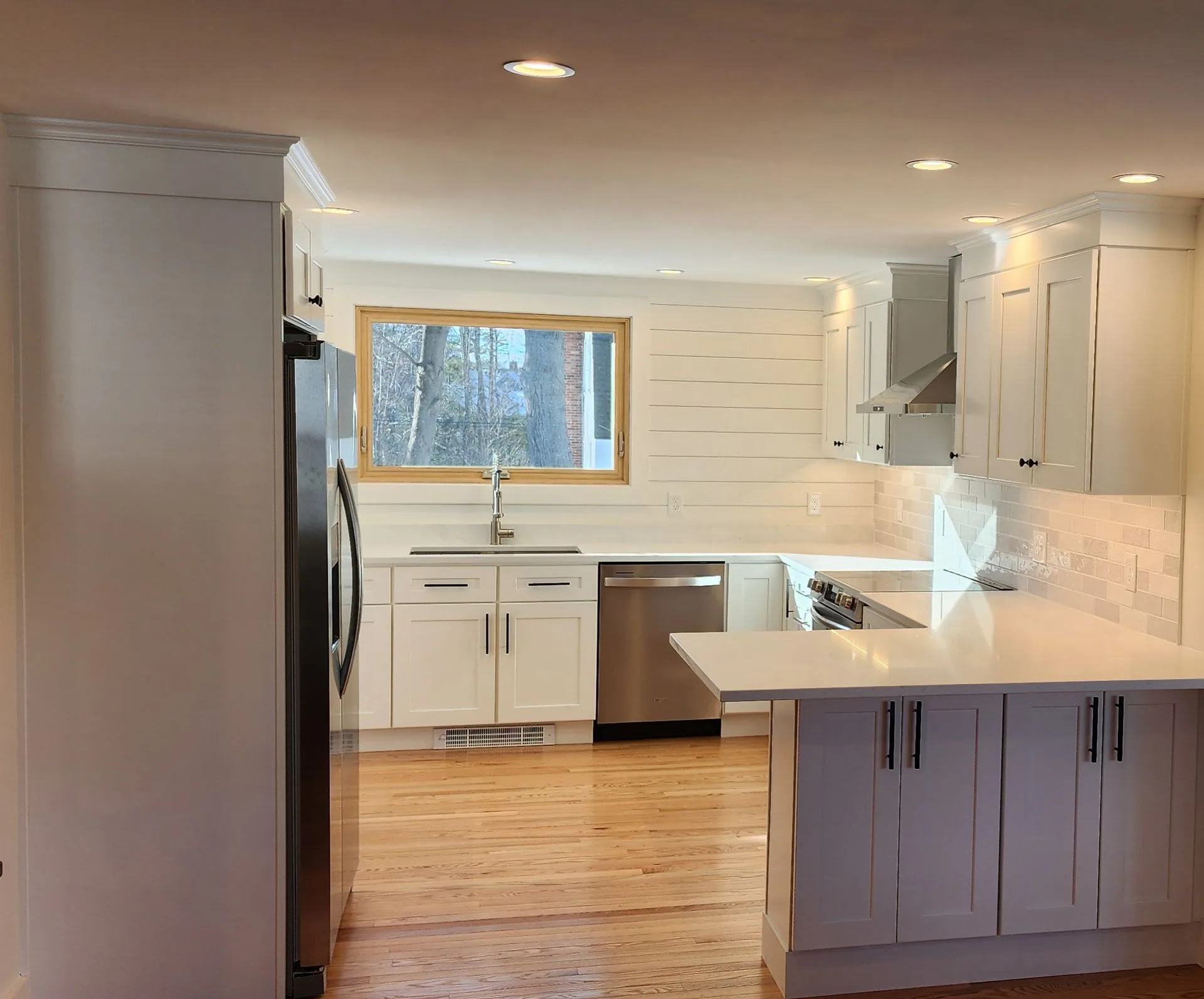 Blue-gray kitchen island with white quartz countertop by Maineland Carpentry